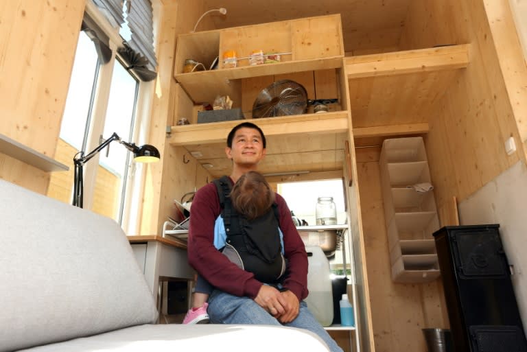 Van Bo Le-Mentzel, head of the Tiny House University Project, sits inside a small house built on the construction site for the project at the Bauhaus Archive Museum of Design in Berlin