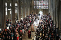 <p>Meghan Markle and her bridal party walk down the aisle of St. George’s Chapel at Windsor Castle for the wedding. (Photo: Danny Lawson – WPA Pool/Getty Images) </p>