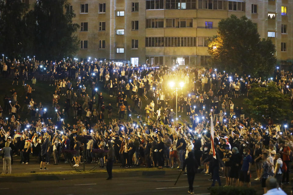 Protesters gather after the Belarusian presidential election in Minsk, Belarus, Sunday, Aug. 9, 2020. Police and protesters clashed in Belarus' capital and the major city of Brest on Sunday after the presidential election in which the authoritarian leader who has ruled for a quarter-century sought a sixth term in office. (AP Photo/Sergei Grits)