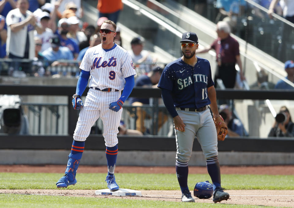 New York Mets' Brandon Nimmo (9) reacts after hitting an RBI-triple against the Seattle Mariners during the fourth inning of a baseball game Sunday, May 15, 2022, in New York. (AP Photo/Noah K. Murray)