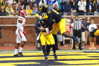 Michigan quarterback Shea Patterson (2) celebrates his four-yard touchdown run with Nick Eubanks (82) in the first half of an NCAA college football game against Rutgers in Ann Arbor, Mich., Saturday, Sept. 28, 2019. (AP Photo/Paul Sancya)