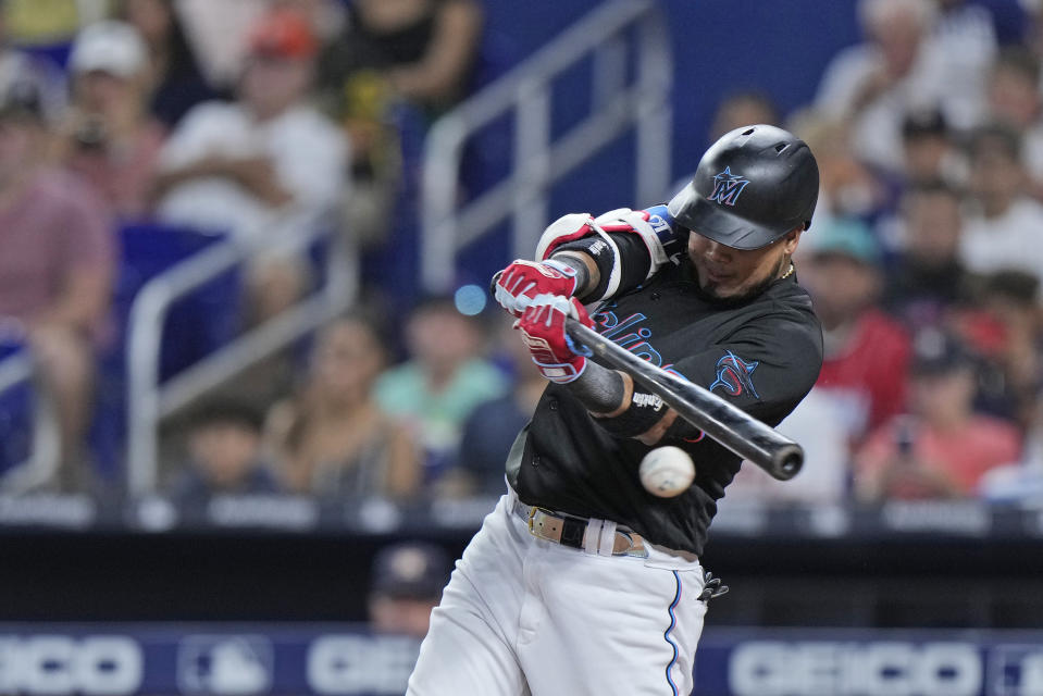 Miami Marlins' Luis Arraez gets a base hit during the first inning of a baseball game against the Houston Astros, Wednesday, Aug. 16, 2023, in Miami. (AP Photo/Wilfredo Lee)