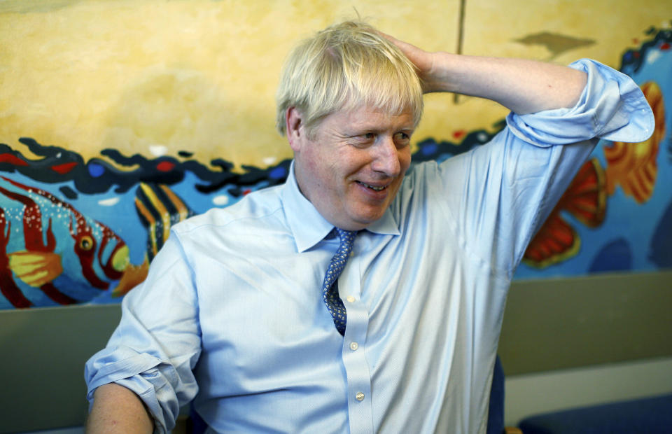 Britain's Prime Minister Boris Johnson speaks with staff during a visit to the Royal Cornwall Hospital in Truro, south-west England, Monday Aug. 19, 2019. Johnson is under increasing pressure Monday to recall Parliament after leaked government documents warned of widespread problems if the U.K. leaves the European Union without a Brexit withdrawal agreement. (Peter Nicholls/Pool via AP)