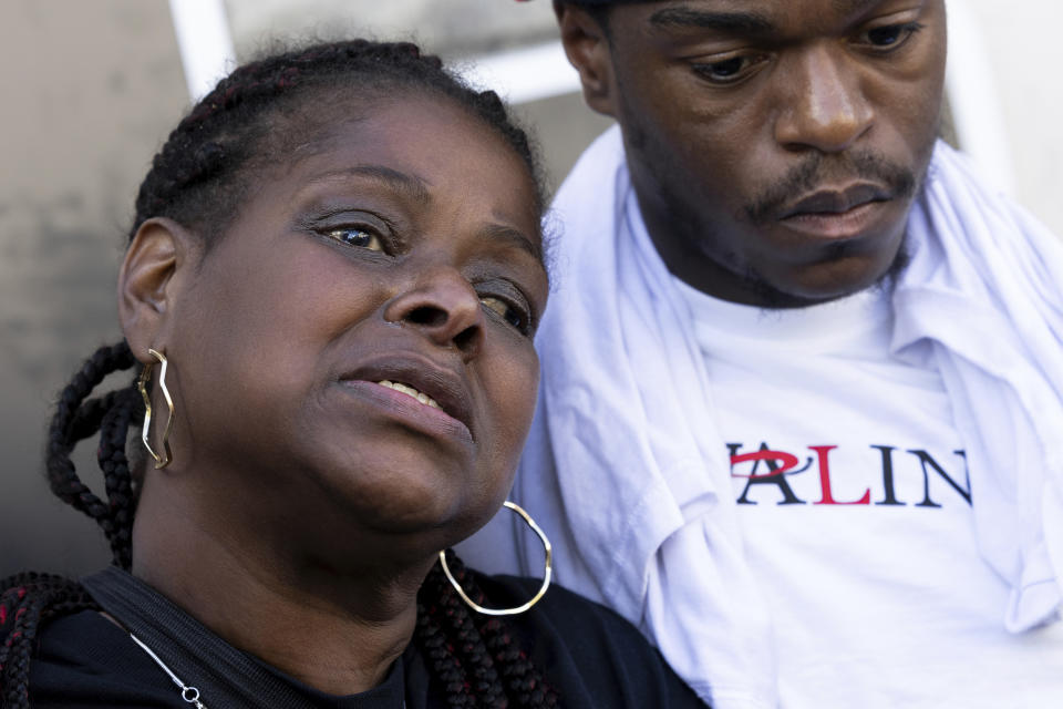 Antonio Moore comforts Antonio Lee's mother at a vigil for Lee, Friday, Aug. 18, 2023, in Baltimore. Lee, 19, was shot and killed while squeegeeing in Baltimore. (AP Photo/Julia Nikhinson)