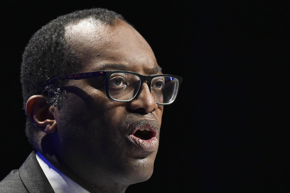 Britain's Chancellor of the Exchequer Kwasi Kwarteng speaks at the Conservative Party conference at the ICC in Birmingham, England, Monday, Oct. 3, 2022. The British government has dropped plans to cut income tax for top earners, part of a package of unfunded cuts that sparked turmoil on financial markets and sent the pound to record lows. (AP Photo/Rui Vieira)