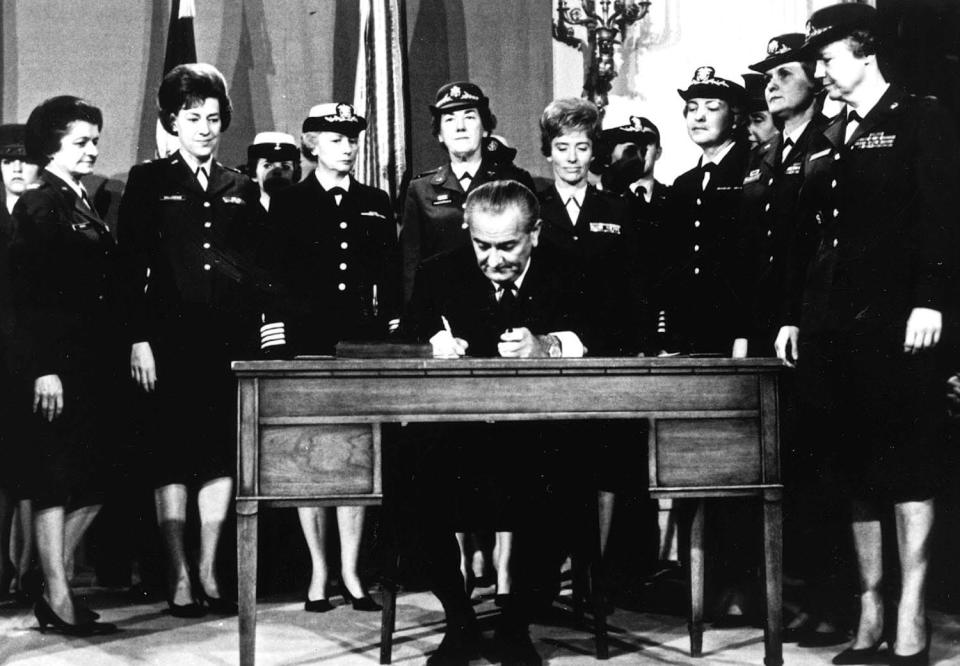 President Lyndon Johnson signs a law on Nov. 8, 1967, that opened military promotions for women and removed the 2% ceiling on the number of women allowed on active duty.