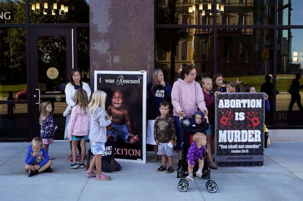 PHOTO: Abortion opponents are seen outside as the Michigan Board of State Canvassers meet during a hearing, Aug. 31, 2022, in Lansing, Mich. On Nov. 8, six states will get a gauge of voter sentiment about abortion, including Michigan. (Carlos Osorio/AP)