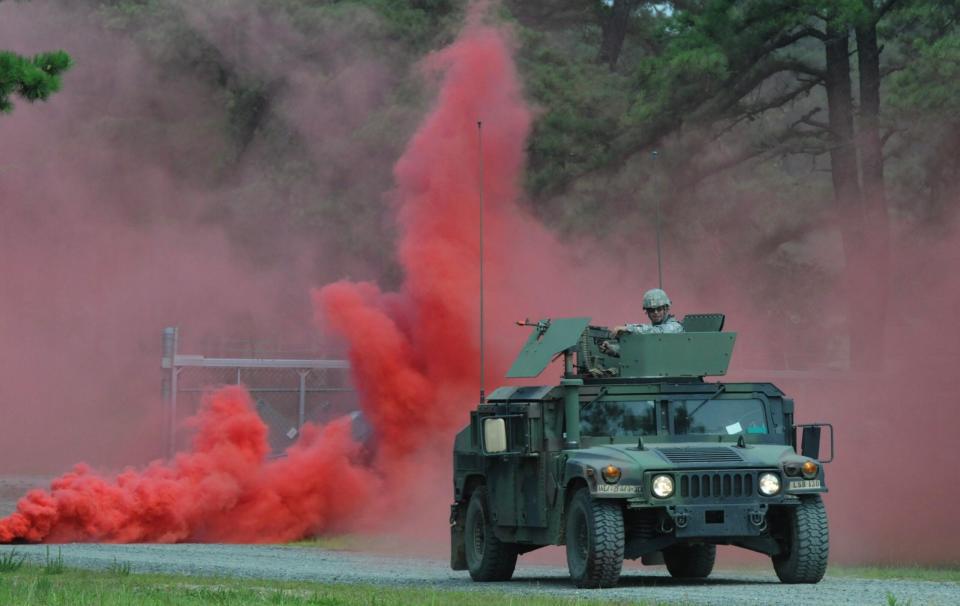 A Humvee rolls through a smoke screen during convoy lanes training during Operation Sustainment Warrior 2014 Joint Base McGuire-Dix-Lakehurst, N.J., August 2, 2014. <em>U.S. Army photo by Spc. Thomas X. Crough/Released</em>