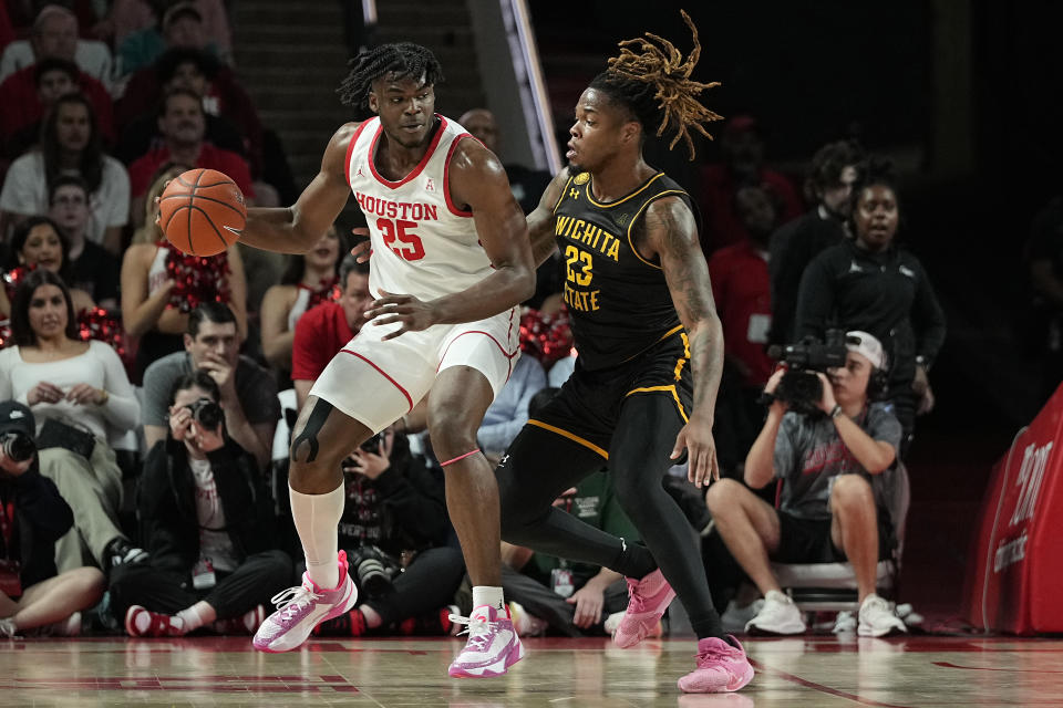 Houston forward Jarace Walker (25) is defended by Wichita State forward Gus Okafor (23) during the first half of an NCAA college basketball game Thursday, March 2, 2023, in Houston. (AP Photo/Kevin M. Cox)