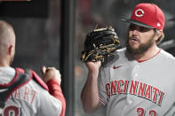 Cincinnati Reds starting pitcher Wade Miley, right, is congratulated by catcher Tucker Barnhart in the dugout in the sixth inning of a baseball game against the Cleveland Indians, Friday, May 7, 2021, in Cleveland. (AP Photo/Tony Dejak)