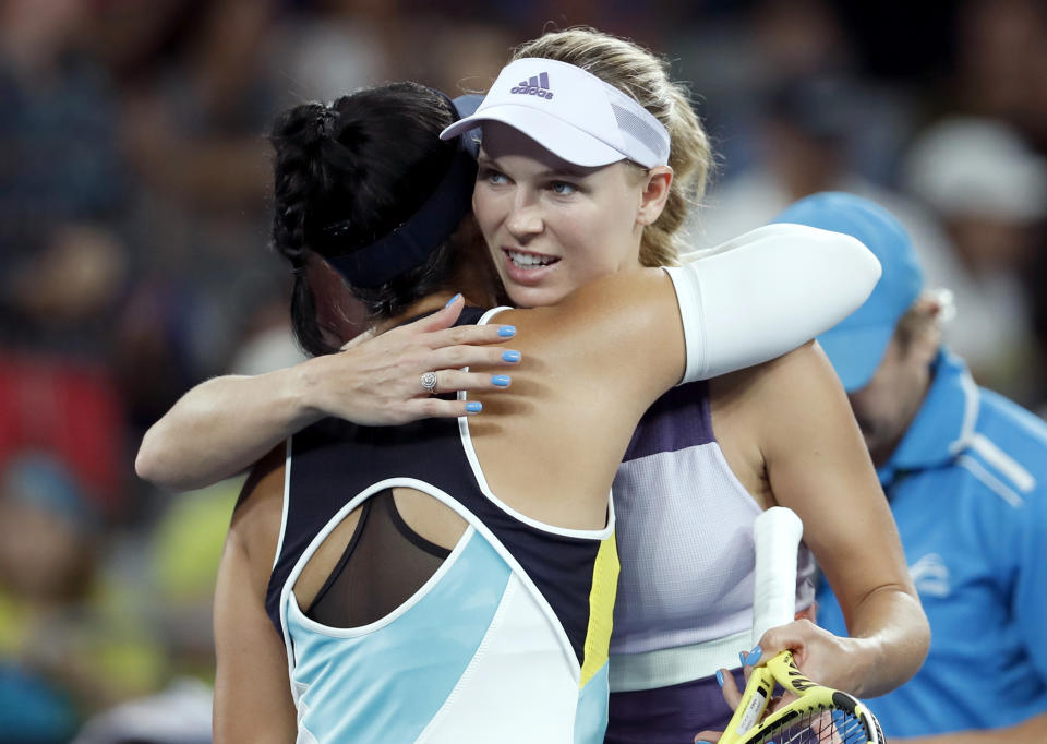 Denmark's Caroline Wozniacki, right, is congratulated by United States' Kristie Ahn after winning their first round singles match at the Australian Open tennis championship in Melbourne, Australia, Monday, Jan. 20, 2020. (AP Photo/Andy Wong)