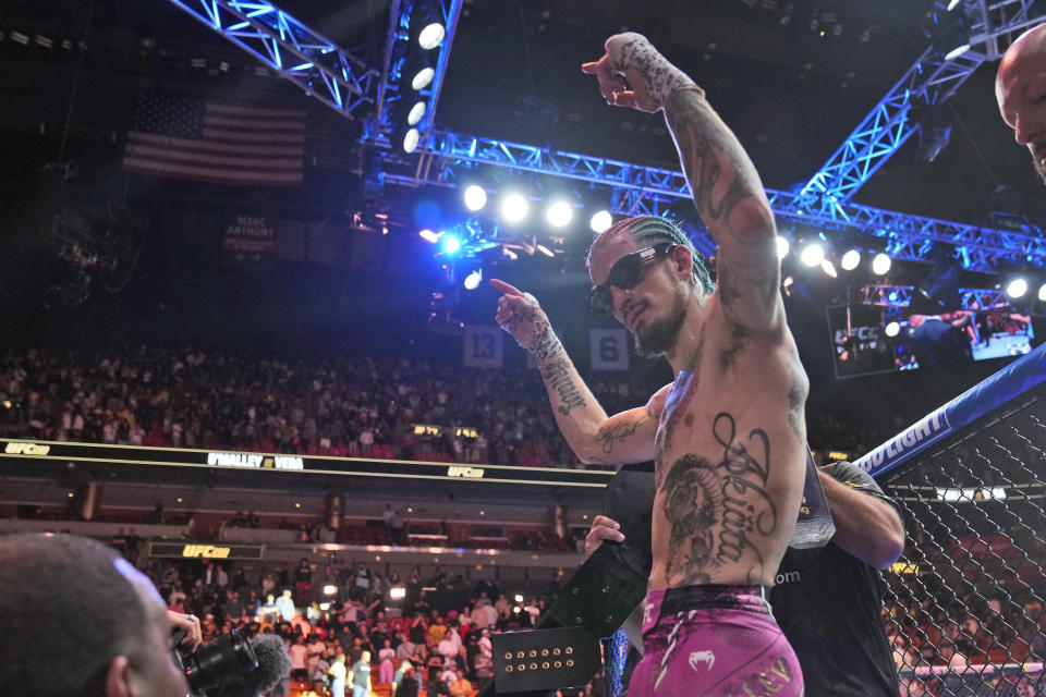 Sean O'Malley celebrates after retaining his UFC bantamweight title against Marlon Vera at the UFC 299 mixed martial arts event, early Sunday, March 10, 2024, in Miami. (AP Photo/Wilfredo Lee)