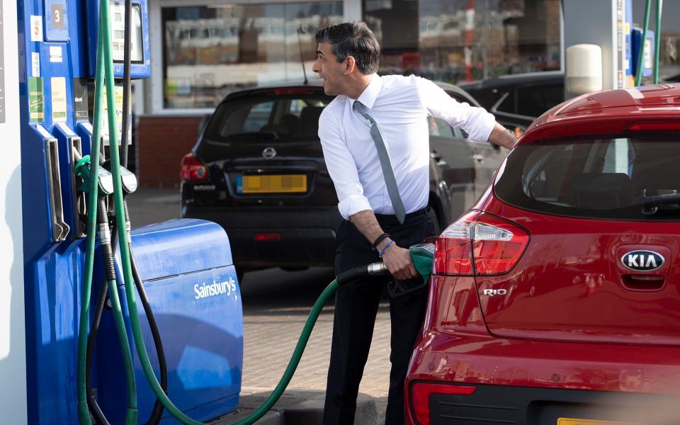 Rishi Sunak fills up a Kia Rio car at a Sainsbury's petrol station - Eddie Mulholland