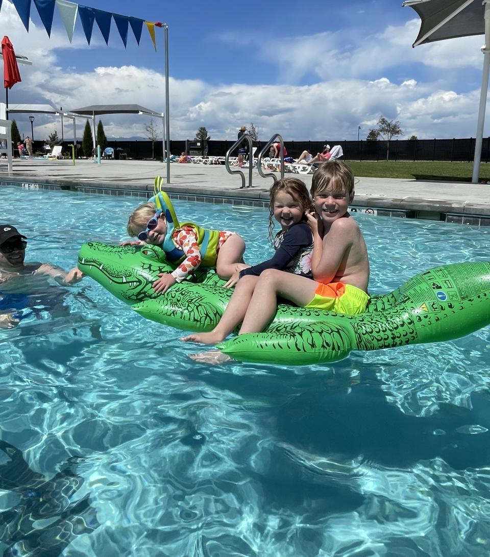 The author's family in the pool with floaties