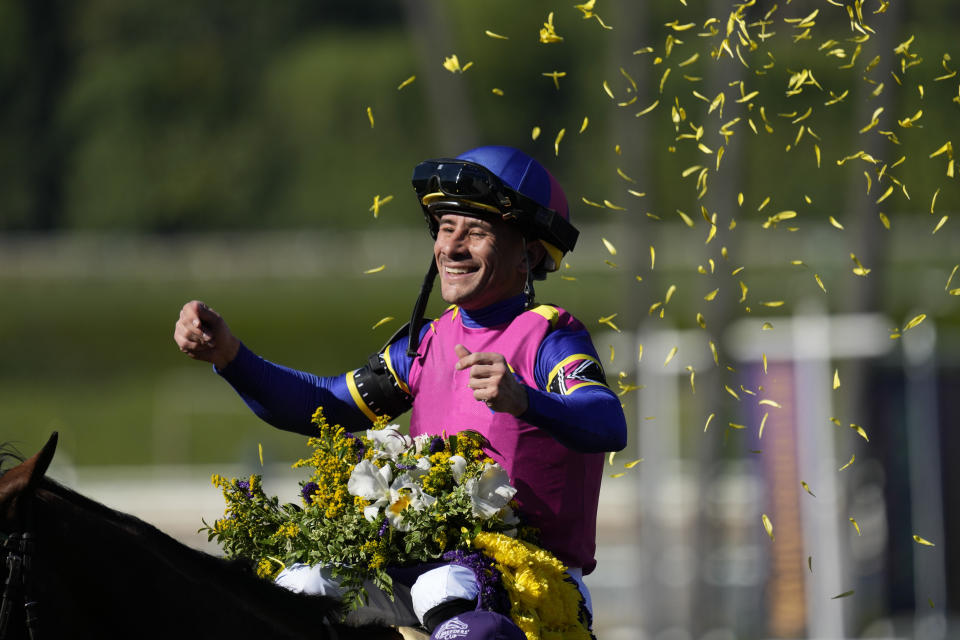 Junior Alvarado celebrates atop Just FYI after winning the Breeders' Cup Juvenile Fillies horse race Friday, Nov. 3, 2023 at Santa Anita Park in Arcadia, Calif. (AP Photo/Ashley Landis)