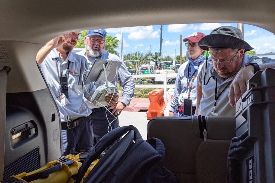 Members of FSU' Center for Disaster Risk Policy team on site at Champlain Towers South: PhD researcher Austin Bush; CDRP director David Merrick; Dr. Robin Murphy of Texas A&M University and FSU researcher Justin Adams.