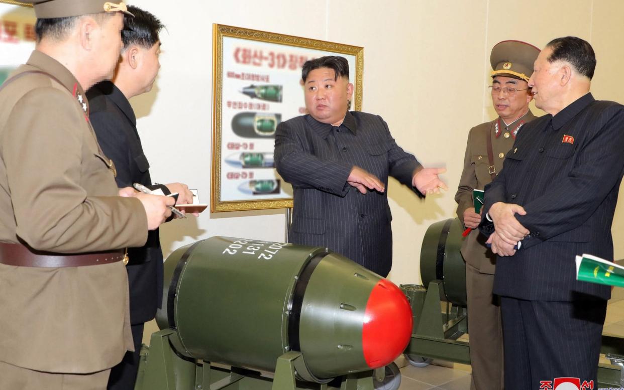 Photos of Kim inspecting multiple warheads at a visit to the Nuclear Weapons Institute were released by the official KCNA newswire - STR