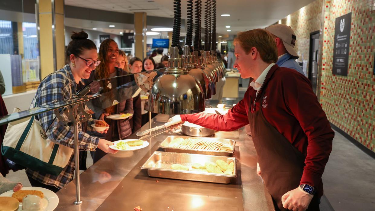 Bradley Cooper, student member of the Missouri State University Board of Governors, serves classmates during the President's breakfast.