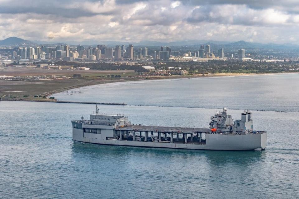 USS John L. Canley in San Diego Harbor in front of the city skyline.