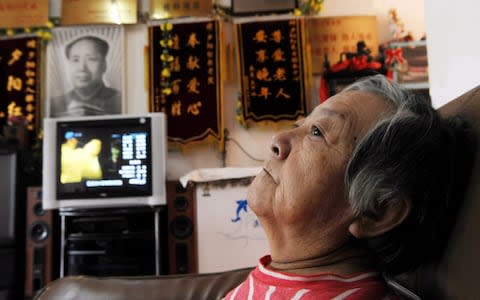 An old woman rests at a resthome in Shenyang, in northeast China's Liaoning province. There is growing concern in China over growing numbers of elderly being cared by dwindling numbers of young. - Credit: EPA