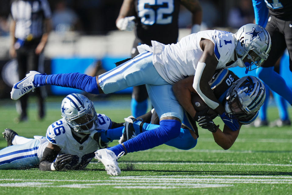 Carolina Panthers running back Chuba Hubbard is tackled by Dallas Cowboys safety Jayron Kearse during the first half of an NFL football game Sunday, Nov. 19, 2023, in Charlotte, N.C. (AP Photo/Rusty Jones)