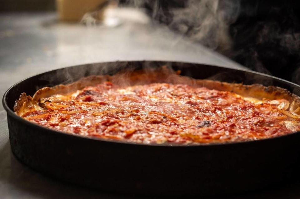 A Zelda’s Original Gourmet Pizza Chicago-style deep dish pizza sits — hot out of the oven and cut upon request — ready to be boxed and served for takeout at the side door of the 21st Street restaurant Tuesday, Dec. 22, 2020, in midtown Sacramento.