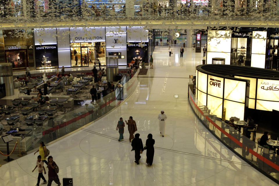 People enjoy their free time at Armani Cafe in Dubai Mall in Dubai, United Arab Emirates, Tuesday, Sept. 25, 2012. Vogue's fashion-loving fans will soon have a chance to drink in the magazine's aura at a new Cafe in Dubai. (AP Photo/Kamran Jebreili)