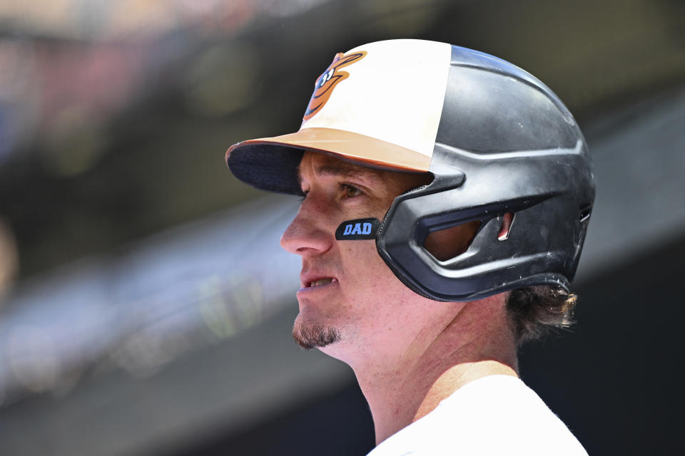 Baltimore Orioles' Austin Hays looks on from the dugout with eyeblack tape that says Dad in honor of Father's Day during a baseball game against the Tampa Bay Rays, Sunday, June 19, 2022, in Baltimore. (AP Photo/Terrance Williams)