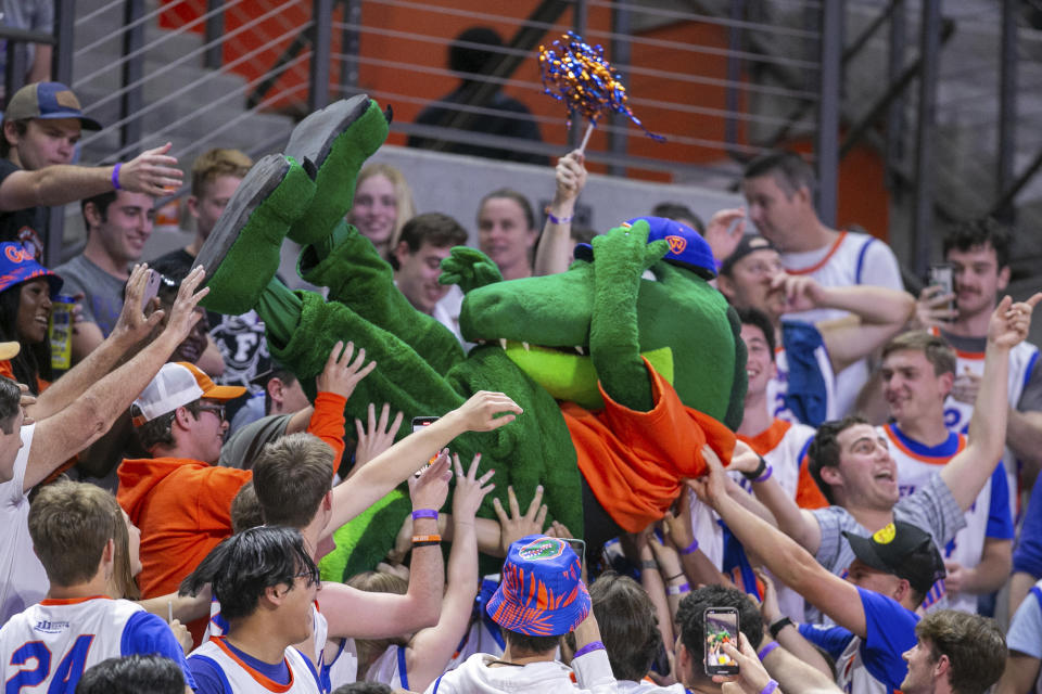Florida mascot Albert gets passed up the seats during the second half of an NCAA college basketball game against Auburn, Saturday, Feb. 10, 2024, in Gainesville, Fla. (AP Photo/Alan Youngblood)