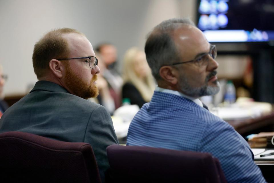 Travis McMichael, left, listens to opening statements at trial at the Glynn County Courthouse, Friday, Nov. 5, 2021, in Brunswick, Ga.