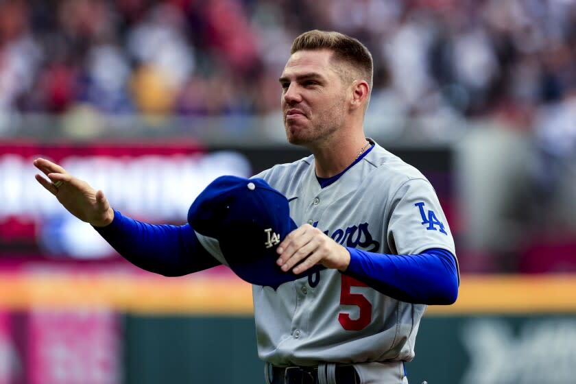 The Dodgers' Freddie Freeman reacts as he is presented his Braves World Series championship ring