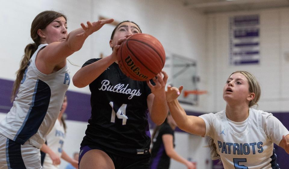 Rumson Ella Mason drive between two Patriots and shoots. Rumson-Fair Haven Girls basketball defeats Freehold Township in Rumson NJ on February 6, 2024.