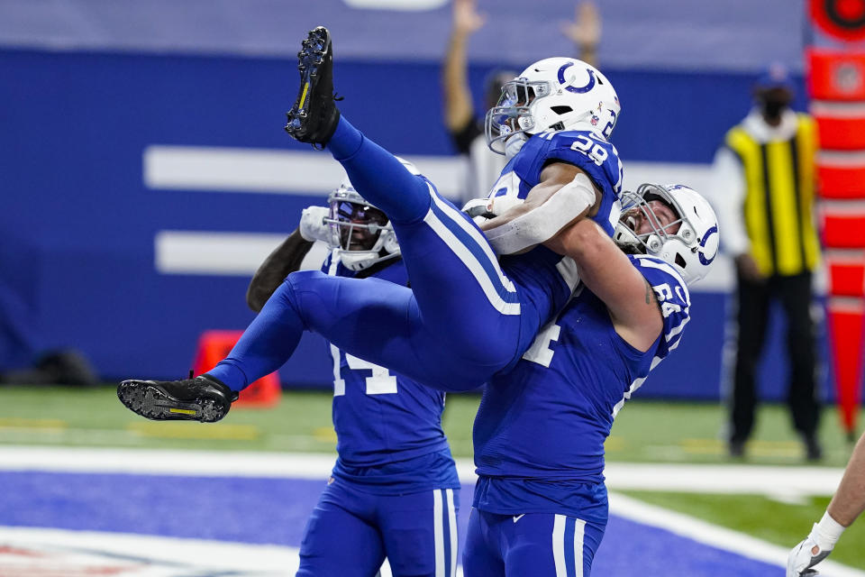 Indianapolis Colts running back Jonathan Taylor (28) celebrates touchdown with offensive guard Mark Glowinski (64) against the Houston Texans in the first half of an NFL football game in Indianapolis, Sunday, Dec. 20, 2020. (AP Photo/Darron Cummings)
