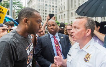 Local activist Darius Rosebrough (L) speaks with Baltimore Police Commissioner Kevin Davis on the second day of pretrial motions for six police officers charged in connection with the death of Freddie Gray in Baltimore, Maryland September 10, 2015. REUTERS/Bryan Woolston