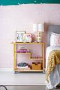 <p>There's no reason why your bar cart can't be used for more than just serving cocktails. Think outside of the box and consider putting it to work as a nightstand, complete with a clock, table lamp, books, and other bedroom must-haves.</p>