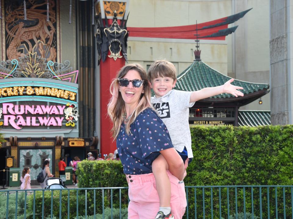 tarah and her son posing in front of mickey and minnie's runaway railway at hollywood studios