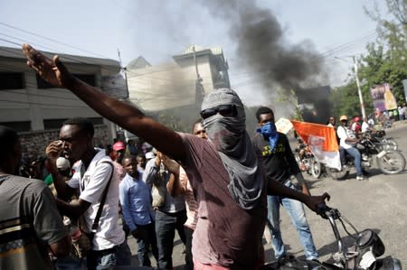 Demonstrators march during a protest to demand the resignation of Haitian president Jovenel Moise, in the streets of Port-au-Prince