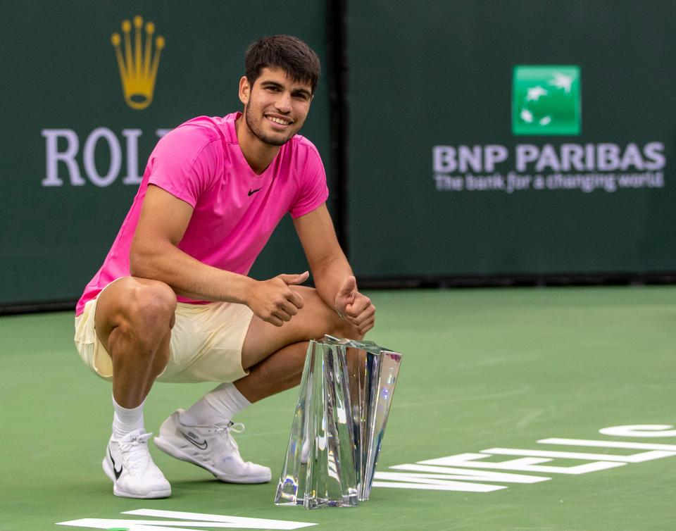 Carlos Alcaraz of Spain poses with the trophy after winning the men's singles final at the BNP Paribas Open of the Indian Wells Tennis Garden in Indian Wells, Calif., Sunday, March 19, 2023. 