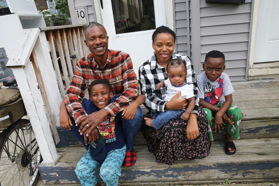 Abel Nimi and his family are among the asylum seekers who arrived in Sanford from Angola earlier this year. They sit outside their apartment Sept. 11, 2023. From left are Abel and his wife, Maria and their three children, Jose, 7, Joseph, 4 months and Abel Jr., 6.