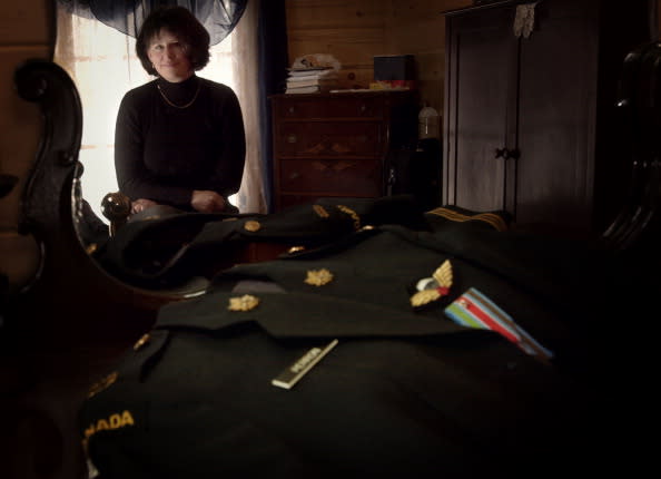 Sandra Perron, Canada’s first female infantry officer, is seen here at home with her old uniform. Photo from Getty Images