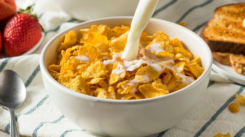 Corn flakes spilling from a bowl