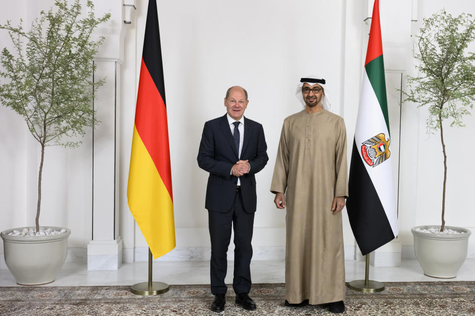 In this photo made available by the United Arab Emirates Presidential Court, Sheikh Mohamed bin Zayed Al Nahyan, President of the UAE right, and German Chancellor Olaf Scholz, pose for a photo prior to a meeting at Al Shati Palace in Abu Dhabi, United Arab Emirates, Sunday, Sept. 25, 2022. (Abdulla Al Neyadi/UAE Presidential Court via AP)