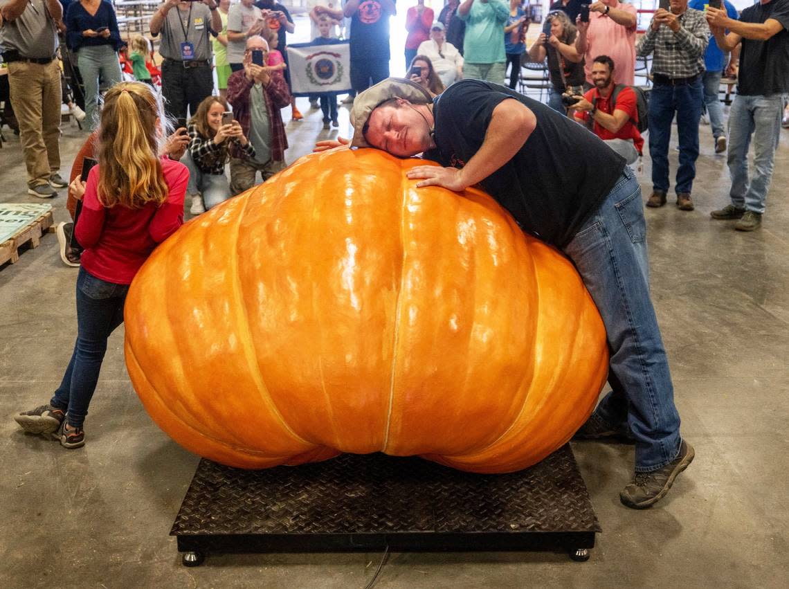 Chris Rodebaugh of Lewisburg, West Virginia, embraces his prize winning pumpkin, which weighed in at 1461 pounds, following the weigh-off for the giant pumpkin contest on Tuesday, October 11, 2022 at the Expo Center for the 2022 N.C. State Fair in Raleigh, N.C.