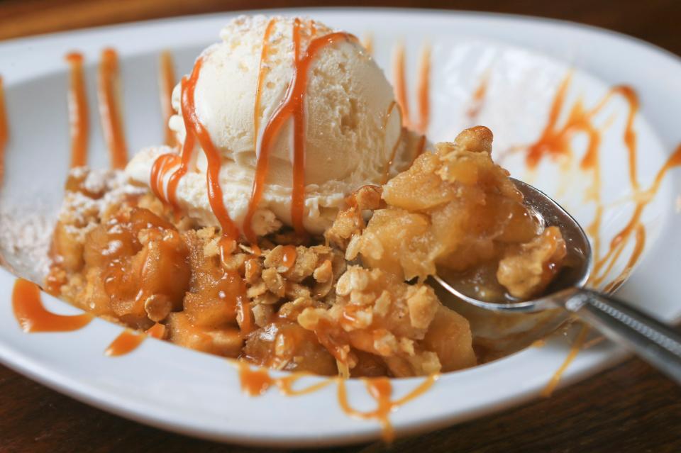 Village Anchor's Huber's Winesap apple crisp includes bourbon-apple cider aramel, with Comfy Cow vanilla bean idea cream and Bourbon Barrel sea salt