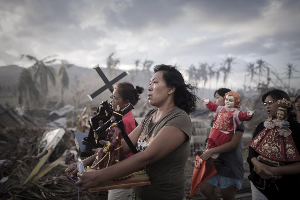 Phillipe Lopez, a French photographer working for Agence France-Presse, won the 1st Prize Spot News Single category of the 2014 World Press Photo contest with this picture of survivors of typhoon Haiyan marching during a religious procession in Tolosa, Philippines, taken November 18, 2013. REUTERS/Phillipe Lopez/World Press Photo Handout via Reuters