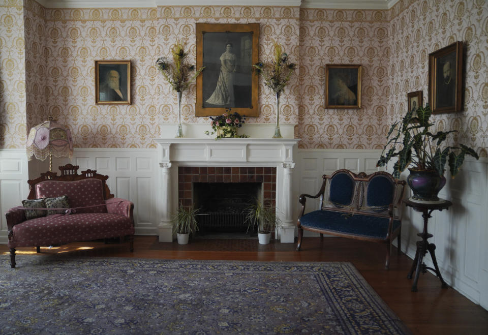 Photos of John Alexander Dowie, founder of Zion, his wife and two children hang on the walls of their former 25-room mansion, which was built in 1902, in Zion, Ill., on Saturday, Sept. 17, 2022. The Zion Historical Society now preserves and maintains the Shiloh House as a town museum. (AP Photo/Jessie Wardarski)