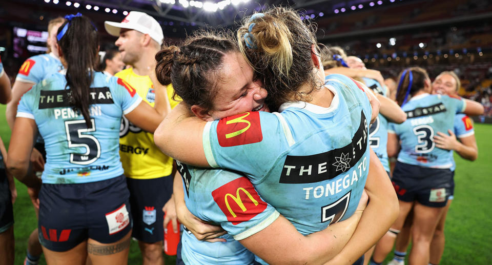Seen here, NSW Blues players celebrate their win over Queensland in Game I of the Women's State of Origin series. 