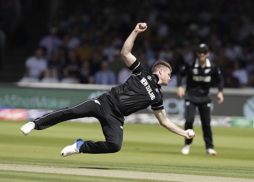 New Zealand's James Neesham dives to his left to dismiss caught and bowled Australia's Glenn Maxwell during the Cricket World Cup match between New Zealand and Australia at Lord's cricket ground in London, Saturday, June 29, 2019. (AP Photo/Matt Dunham)