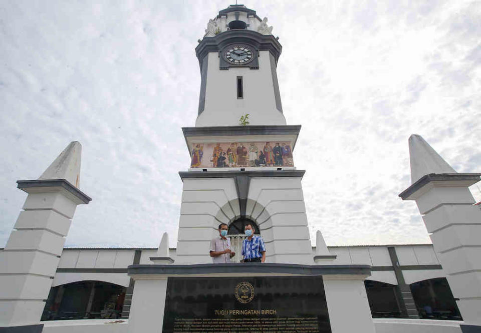 Time Recorder Sdn Bhd sales managers, Ui Foo Ming 53 (left) and Choo Kok Leong at the Birch Memorial Clock Tower, in Ipoh. — Picture by Farhan Najib