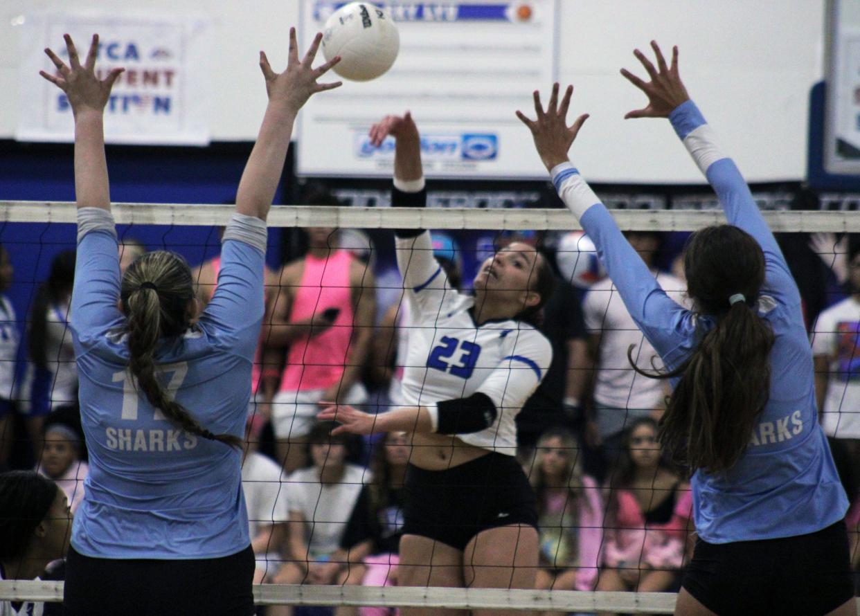 Trinity Christian's Mari King (23) spikes the ball against Ponte Vedra's Morgan Sutton (17) and Ryan Murphy (7) during a high school volleyball match on October 2, 2023. [Clayton Freeman/Florida Times-Union]